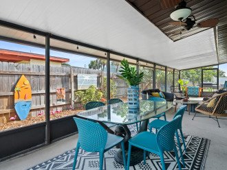 Expansive screened patio with dining table & conversation seating.