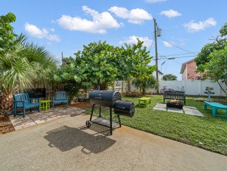 Spacious, fully fenced backyard with bbq grill, firepit, loungers & games.