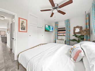 Bedroom 2: Smart TV & ceiling fan.