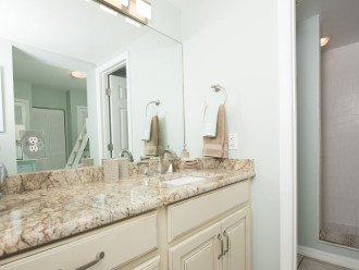 Guest bath adjacent to 2nd bedroom has vanity area separate from toilet/shower