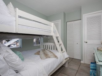 There is a stacked washer and dryer in the closet in this bedroom