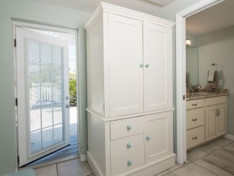 Pantry cabinet in area adjacent to kitchen. Side door leads to parking area