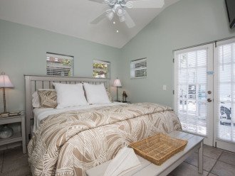 Master bedroom with king size bed and nightstands with reading lamps