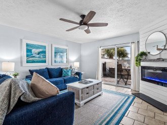 Living room decorated in cool coastal colors and photos to match