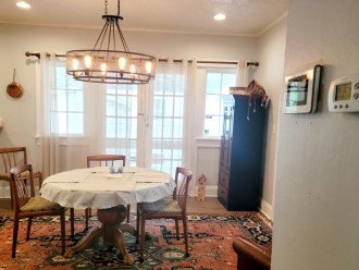 Dining Room, French doors to portico with gas grill. Notice ADT, AC panels.