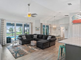Open concept living room with oversized sectional and 8' sliders