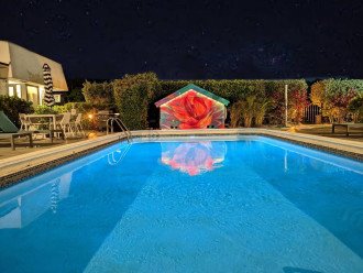 Featuring pool house mural with LED lights at night.