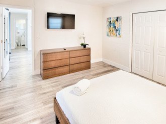 Primary bedroom with 40" smart TV and dresser