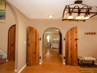 From the foyer, the farmhouse arch doors leads to you a large first floor master bedroom with en suite bath
