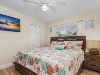 KING BED GUEST BEDROOM 3 (king bed, 65" smart TV, walk-in closet)**Pool / Lanai / Dock / BBQ area view as well as garden views (Papayas, mangos, palm trees, hibiscus plants)***