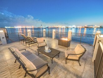 The deck featuring a fire pit is an excellent place to unwind and enjoy the breathtaking views or go fishing.
