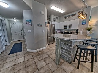 Spacious kitchen with new appliances and seating at the bar