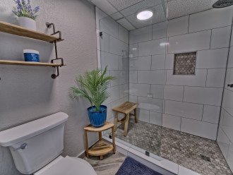 King master bath has a brand new tile shower with a glass door and teak benches for your accessories or to sit while showering