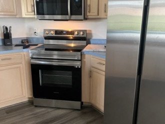 newly appointed flooring and stainless steel appliances