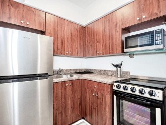 Kitchen with stainless steel appliances. 2m video tour includes open cabinets to show supplies.