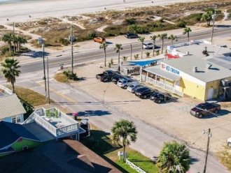Drone view from beach house (with 2 palm trees in front) Thomas Donuts across st