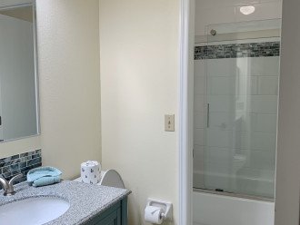 Jack and Jill bathrooms (2 separate 1/2 baths joined by tub/shower in the middle) updated in 12/2021 feature comfort height elongated toilets, new tub and tile with mold and mildew free tempered glass shower doors. Master WC shown.