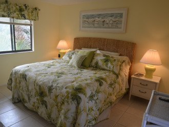 The primary bedroom features a Serta King premium quality pillow top mattress with Tommy Bahama bedding, LCD TV and DVD player. Window faces empty natural lot next door for extra privacy.