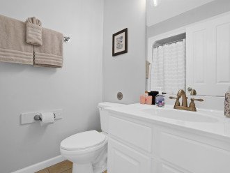 En suite bathroom for Queen bedroom featuring shower/tub combo