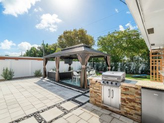 Custom built-in grill with a burner, and an outdoor fridge for your favorite cold beverages!