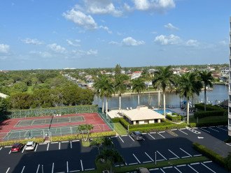 View of the tennis courts, pool, bocce ball and parking lot from the front door