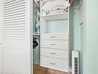 A large bedroom closet with convenient luggage racks for unpacking.