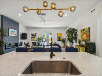 Contemporary design full kitchen, quartz countertop, contemporary barstools, open space for dining area, and central entertainment areas.