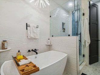 Relax in a large spa tub, chandelier for a romantic/relaxing bath, separate showers, and private leisure room.