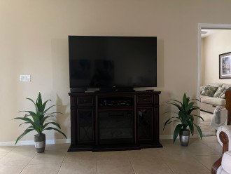 Large Flatscreen TV with Soundbar, Cable and Electric Fireplace