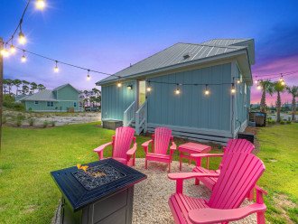 Fire pit area comes with 4 solid wood Adirondack chairs, table & café lights.
