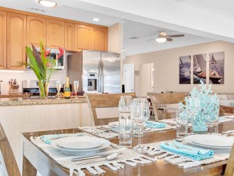 The kitchen / indoor dining room has a view of the pool and the waterfront. You will love this newly remodeled design.