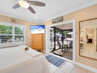 Bedroom 3 boasts a king bed and has direct access to the screened-in outdoor seating area. Perfect for sipping your morning coffee or enjoying the view of the pool and waterfront.
