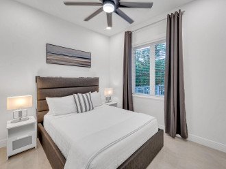 Bedroom Six boasts a queen size bed, a smart TV, and an ensuite bathroom.