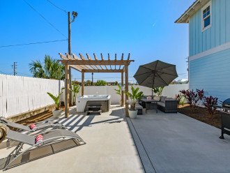 Backyard Oasis offers a grill, seating area, loungers, hot tub & hammock