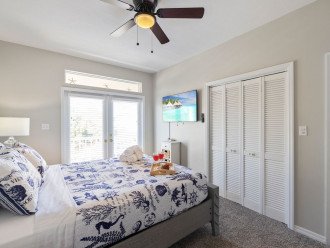Queen Bedroom with tv, access to shared balcony.