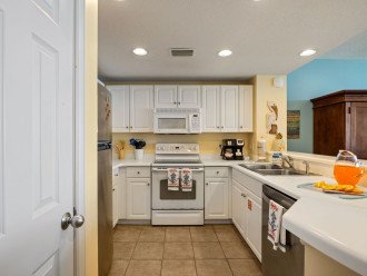 Kitchen offers dual coffee maker, blender, microwave & dishwasher.