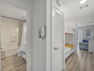 The functionality of the flow of the condo is perfect for evyone to have their own space. This shows the ensuite master bath with another access off the hall, the bunk beds and living room - separated by a pocket door.
