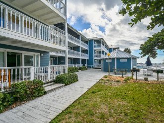 The bottom condo on the left is your home away from home. Steps away from the grassy area, grilling station, pool, Hottub, gazebo and beach