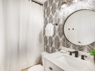 Modern bathroom with fun accents throughout! Adjustable overhead lighting, and bath/shower combo.