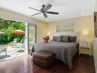 Room 1: Private deck overlooking pool from master suite with king bed.