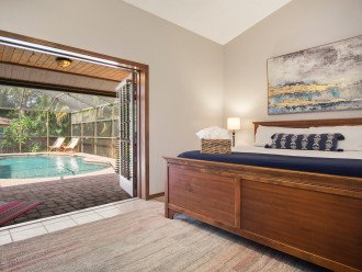 Primary Bedroom w/ French Doors that Open to the Pool