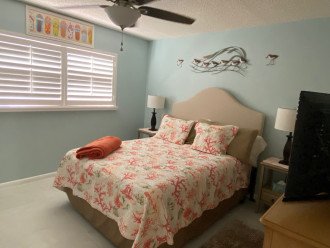 Queen bed and large smart TV in guest bedroom