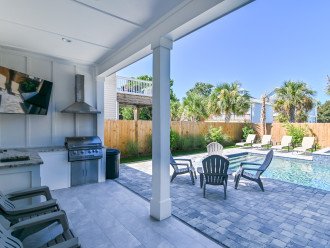 outdoor kitchen with TV, watch movies and sports from the pool