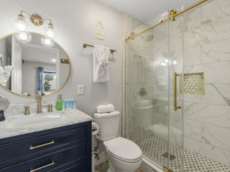 Luxury private bathroom off of the primary suite featuring a gorgeous shower and all of the amenities you need!