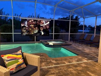 At Night Watch Movies And TV While Lounging Around The Pool