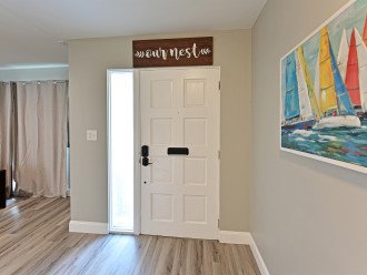 Your Entrance to Your Gulf Coast Retreat with Gorgeous Hardwood Floors & Floridian Decor