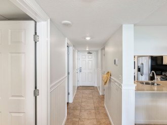 After accessing the condo via convenient keyless entry, make your way through the entry hallway to the open-concept space that includes kitchen, dining area, and living room.