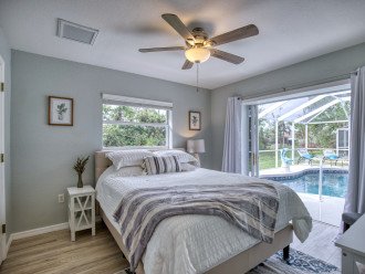 Guest bedroom off the pool with walk-in closet, double sliding pocket doors.