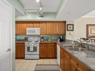Fully equipped kitchen with pantry, refrigerator, oven, stove & microwave.