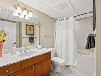 Second full bathroom with shower, vanity, and bathtub.